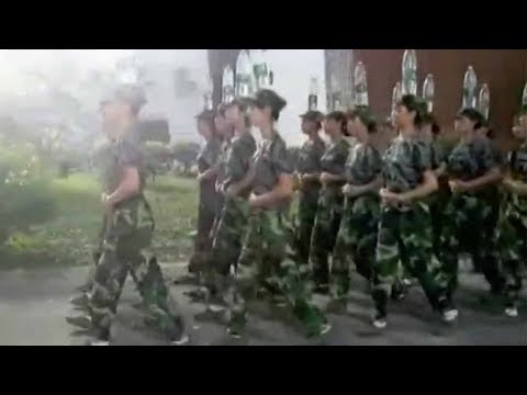 cadets march while balancing water bottles